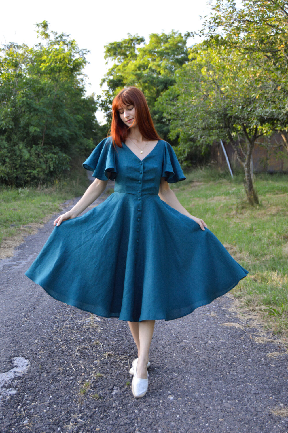Women's linen dress Charlotte in petrol color, with a V-neckline, buttons and butterfly sleeves Women's linen dress Charlotte in petrol color, with a V-neckline, buttons and butterfly sleeves